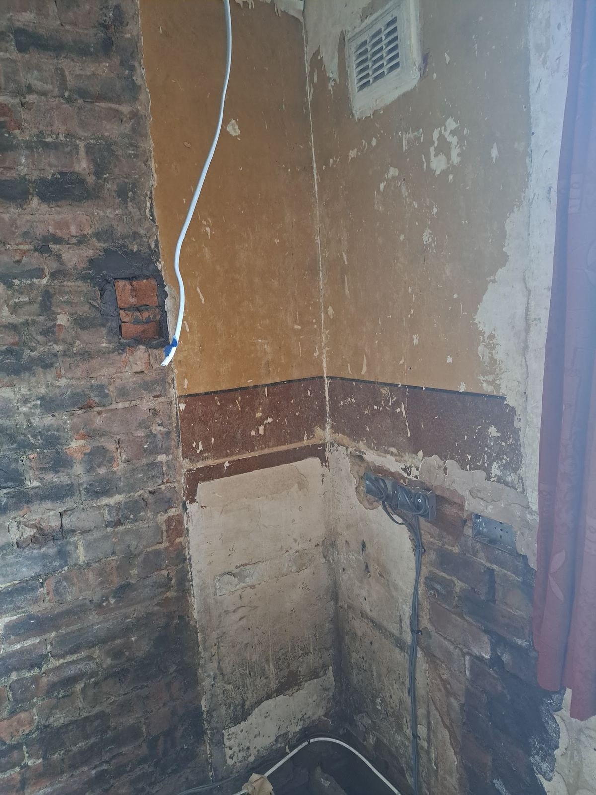 Chimney breast removed, leaving bare brick
