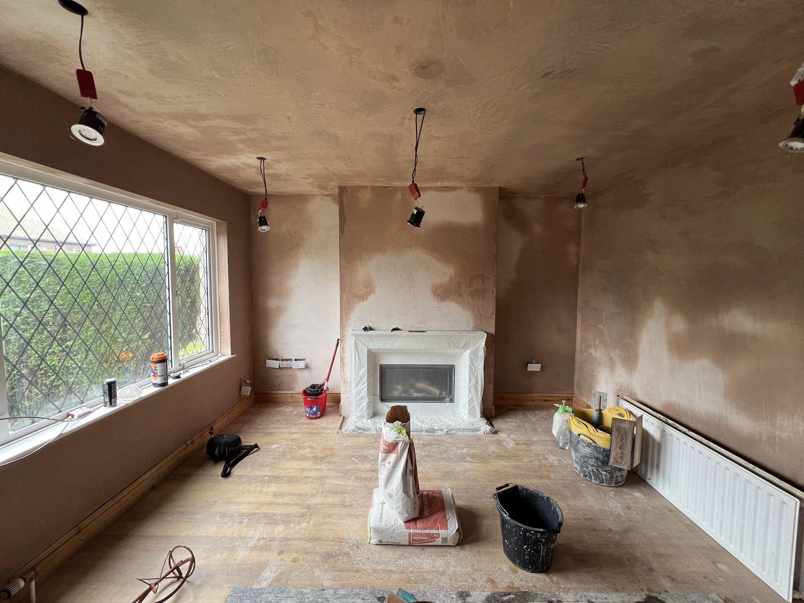 Whole house plastered with fresh pink skim drying