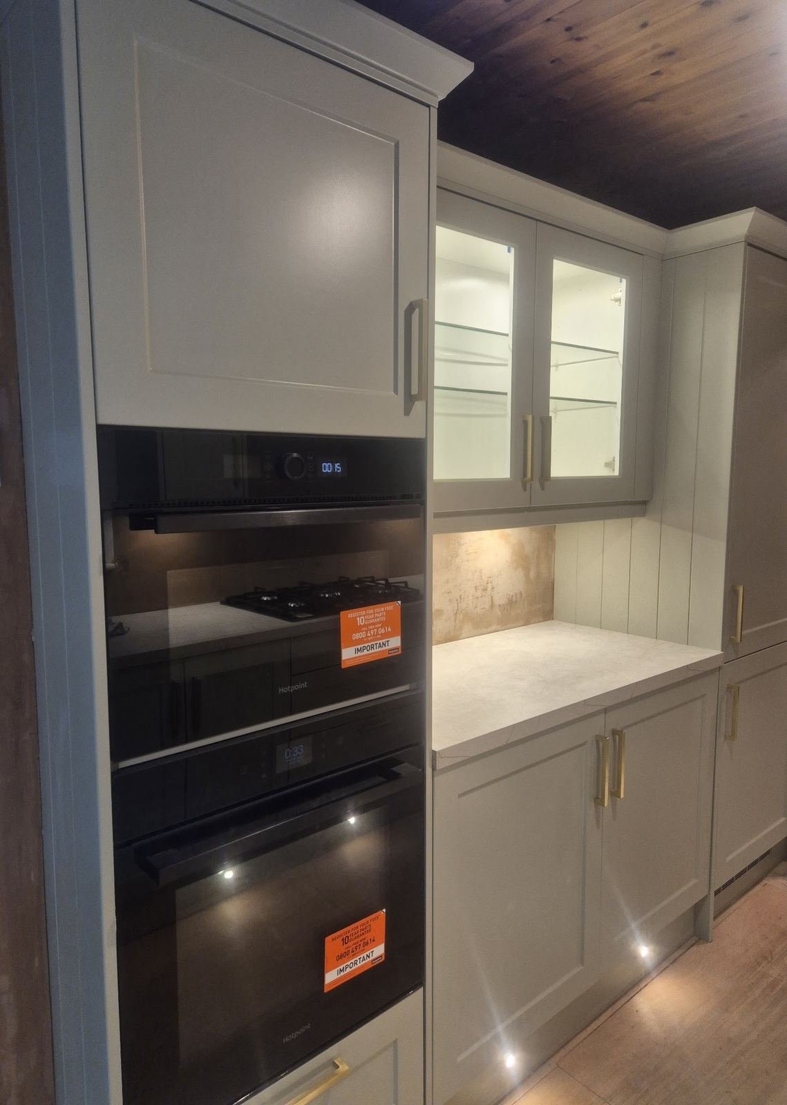 Walls plastered around built-in ovens and cabinets
